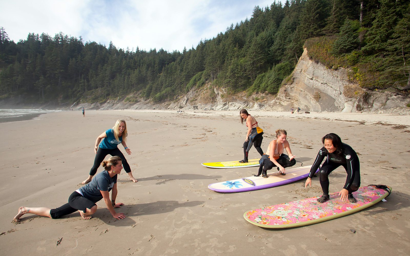A group of women prepare to learn surfing in Oswald West State Park. Photo by Justin Bailie.